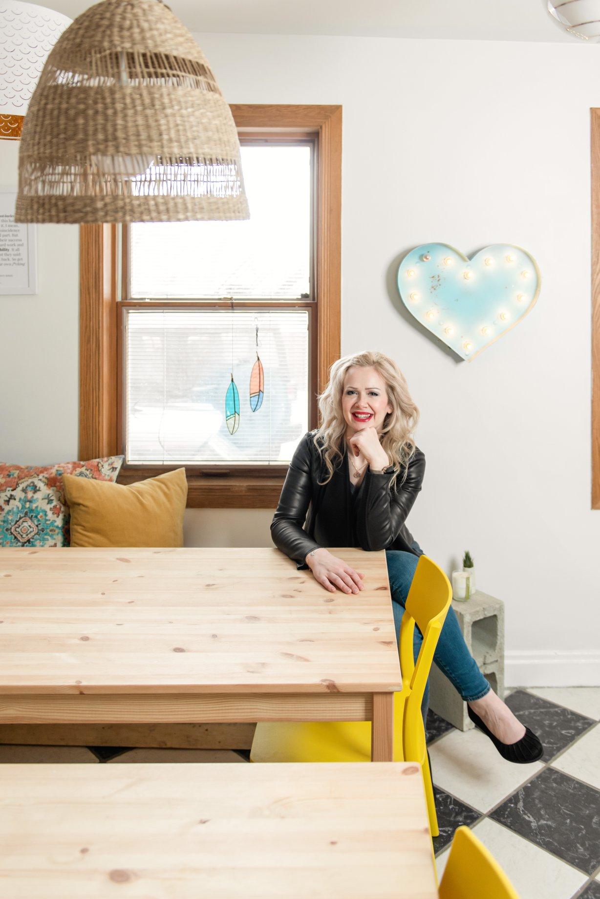 Sarah sitting at a desk with hands on a laptop